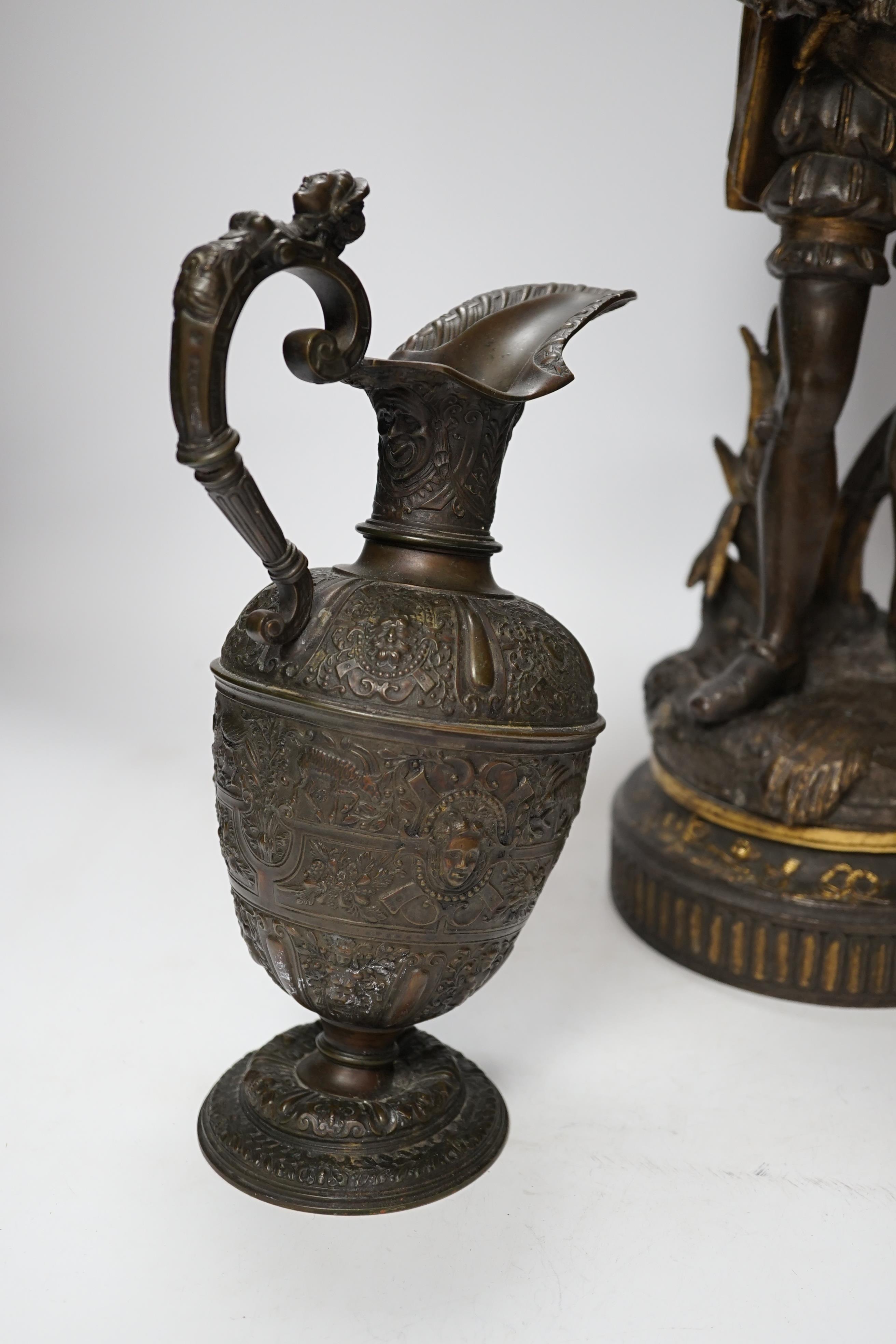 A 19th century parcel gilt and bronzed spelter figure of a cavalier, together with a Florentine style bronze ewer, 49cm high (the latter a.f.) (2)